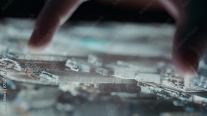 Close up of fingers navigating 3D satellite map on a tablet. Slow motion.