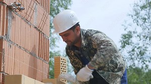 Construction site: building a brick house. The process of brickwork
