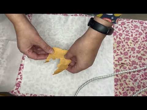 An autumnal scene from fabric using bond-a-web to create a collage.