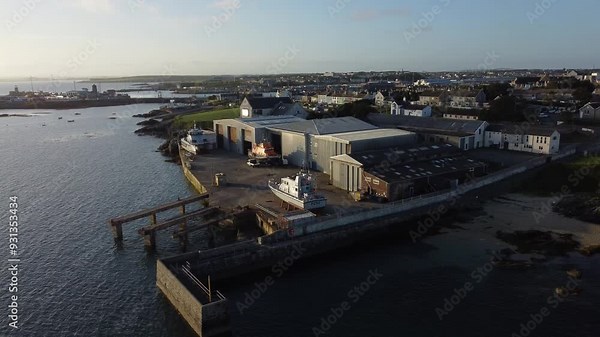 Holyhead boat maintenance shipyard aerial sunrise rising view over harbour warehouse waterfront