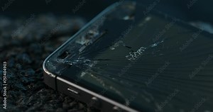 A smartphone lies broken on the ground, its screen showing a poignant call labeled 'Mom' amidst an accident or crime scene.