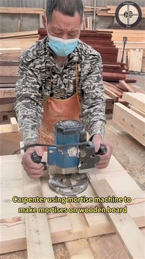 Carpenter using mortise machine to make mortises on wooden board
