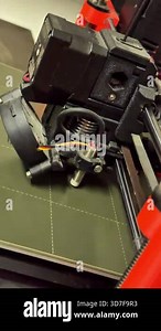 Close-up view of a 3D printers extruder mechanism, highlighting intricate movements and mechanical components, demonstrating advanced technology