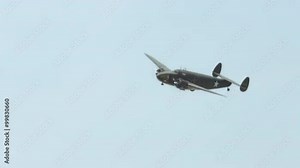 Historic World War II military transport aircraft, Lockheed C-60 Lodestar, flying in cloudy sky. Recorded in 4K, ultra high definition. Stock Video