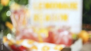 Raspberry lemonade garnished with fresh lemon and raspberries in drinking mason jars