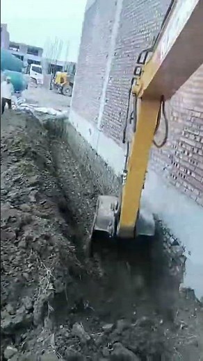 Digging ground around house edges for proper foundation work