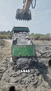 This dump truck is loaded with dense clay that sticks firmly to the bed. | Salud Studio