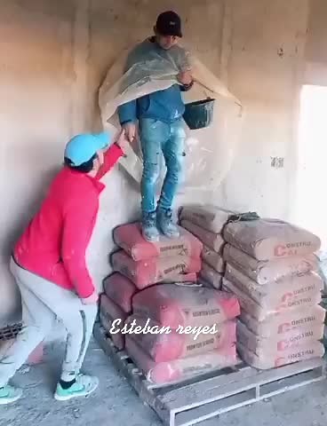 Construction Teamwork: Climbing Cement Sacks Together