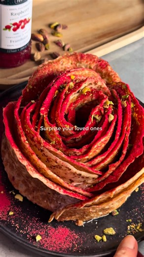 Dreamy Vegan Recipes on Instagram: "Crepe Rose 🌹✨ Watch until the end to see what simple crepes can turn into 🌹 This crepe rose is filled with raspberry fruit spread from St Dalfour, made with 100% fruit, layered with creamy vegan yogurt, and finished with a dusting of strawberry powder and crushed pistachios. A beautiful, delicious way to celebrate Valentine’s Day! ❤️✨🥰 ❤️ Ingredients (Makes 15 crepes) • 180 g all-purpose flour • 600 g plant milk (soy, oat, or almond) • 15 g sugar (optional)