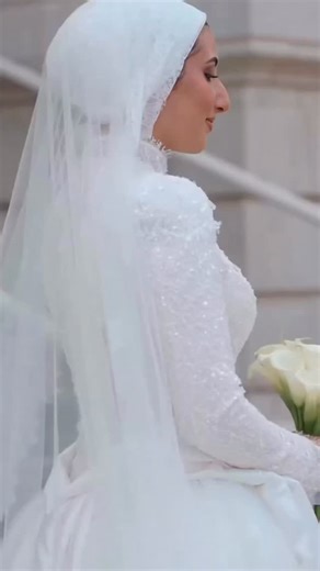 “Wow” truly is an understatement 👏 Designing @jeninsalus’s wedding dress was an absolute honor- creating for the Salous family always makes our hearts so happy ✨ We brought our Pixie gown to life with a continuous nude lining for a modest yet elevated look, paired with our signature turtleneck illusion neckline. The final touch: a sleek back zipper and a stunning satin and tulle overskirt. Bridal Gown: @dinahawidiofficial Bridal Veil: @dinahawidiofficial Photographer: @mo.jayyousi | Bridal Conc