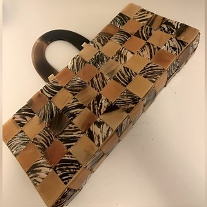 Sleek Artisanal Clutch with hand stitched shell tiles and handles