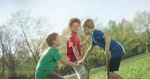 Multicultural kids group hands on top of each other outside