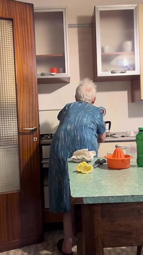 Elderly Woman's Kitchen Routine: Warmth and Wisdom