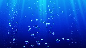Animation of moving up water bubbles underwater. Background of blue clean sea or ocean underwater surface. Animation of seamless loop.