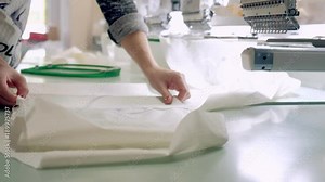 Textile - Professional and industrial embroidery machine. Machine embroidery is an embroidery process whereby a sewing machine or embroidery machine is used to create patterns on textiles.