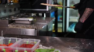 The chef holds the pizza on the spatula. Catering kitchen work