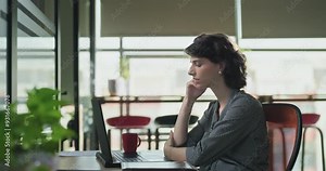 Angry tired young adult gen z woman staff sitting use laptop look screen talk rude online video call shout lady client job office sad upset teen female girl distant fight fail deal bad day work place