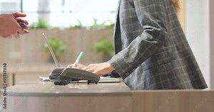 Customer use credit card scanner machine at cashier and confirm button to pay service or product shopping purchase. Digital banking payment checkout hotel. Buy food and drink in restaurant
