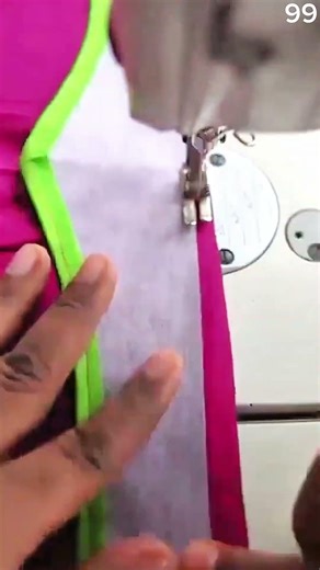 Hand guides green cord through sewing machine