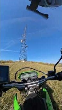 Investigating a cell tower atop a scenic hillside
