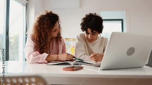 Mother helping her son with homework at home