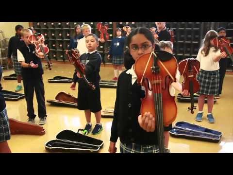 First violin lesson for 4th graders at Valley Catholic Elementary