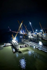 Dam building with crane