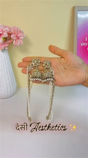 Variety- The Beauty Junction on Instagram: "@varietythebeauty This classic Kundan pearl Jhumka features a square-shaped Kundan mirror centerpiece surrounded by delicate filigree work, leading into a dome enriched with high-quality pearls and tiny bead detailing. The Jhumka bottom is finished with clustered pearls for a traditional handcrafted look, supported by multi-layered pearl ear chain strands that drape gracefully. Each bridal ear chain is lined with oval pearls bordered by miniature beads