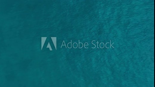 Ocean surface aerial view, sea water texture background by drone. Flying over the blue ocean in the azure lagoon. Travel concept. Aerial footage. Slow motion 120 fps video