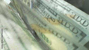 Finance and cash dollars concept. Counting dollars with electronic money counter machine. 100 dollar bills counted in money counting machine. Cash money dollars into banknote counter.