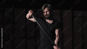 Strong man Hitting Wheel Tire With Hammer Sledge Crossfit Training, Young Healthy Guy Gym Interior night cinematic dark workout Stock Video