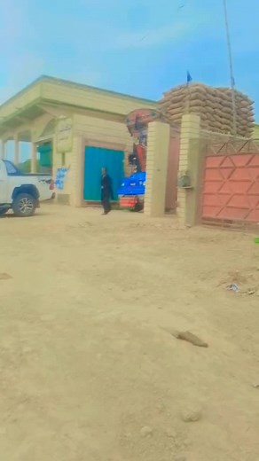 Large Blue Truck with Grain Bags in Rural Setting