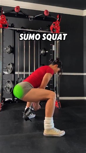 Ariel_yu on Instagram: "Dumbbell Sumo Squat - How to Target the Glutes 1. Dumbbell Position Hold the dumbbell with both hands naturally hanging between your legs, rather than holding it at your chest. This allows you to lift heavier weights without being limited by arm strength. 2. Torso Posture Maintain a slight forward lean instead of staying fully upright. Leaning forward increases hip flexion, helping to stretch and better activate the glutes. 3. Stance Width and Foot Angle Set your feet abo