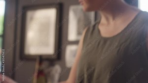 Close-up of a woman clerk at a record store checking out at customer