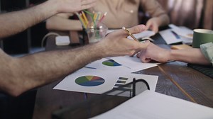 Close up of business hands team working on statistical data at table | Free Stock Video Footage