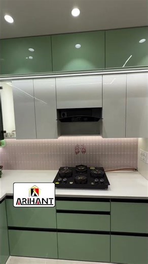 High-gloss laminate) finish modular kitchen with glass shutters and granite countertop.