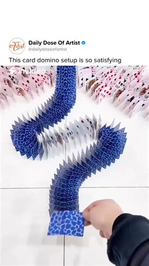 Daily Dose Of Artist on Instagram: "Longlong Who Loves Arranging Cards is a Chinese creator known for crafting detailed domino-style arrangements using playing cards. He carefully places each card on the floor, forming intricate paths, curves, and patterns where precision is essential. Once everything is aligned, he tips the first card and allows the chain reaction to flow, creating a smooth, satisfying domino effect that reflects both planning and creativity. His videos highlight patience, cont