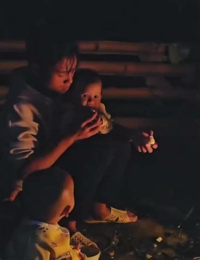 Single Mother cooking food for baby at night