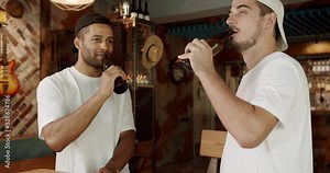 Group of friends drinking beer, chatting and having good time at pub. Male colleagues in good mood drinking draft beer and relaxing. Young people enjoying themselves and communicating in pub concept.