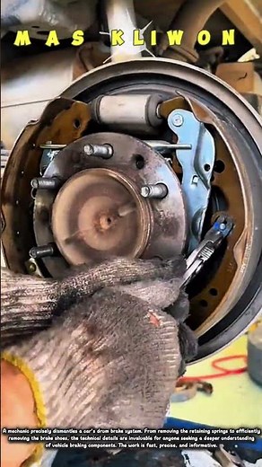 A mechanic dismantles a car's drum brake system with precision.