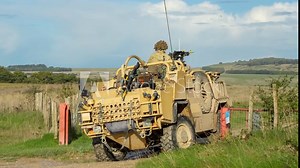 close-up of a British army Supacat Jackal rapid assault and reconnaissance vehicle in action, military battle exercise Stock Video