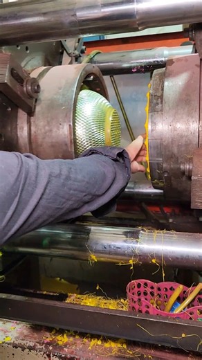 He opened the door of a strangely large machine and took out the sieve that had been made inside.