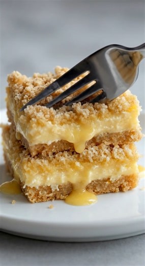 🍋 Irresistible Lemon Crumb Bars | Buttery layers, creamy lemon, and that perfect bakery crumble ✨ These **lemon crumb bars** are one of those desserts that hit every note — buttery, soft, lightly crisp, and filled with a silky lemon layer that’s bright without being too tart. Each bite melts together: tender shortbread-style crust, creamy lemon center, and a golden crumb topping that tastes straight from a bakery case. They’re the kind of treat you slice “just a little piece” of… and somehow go