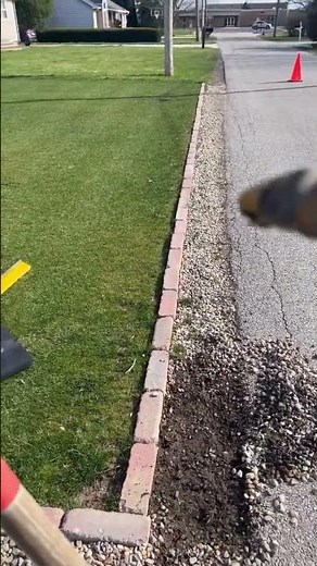 Fixing brick edge around the lawn.