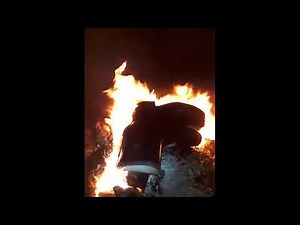 rubber boots burn in a large cauldron