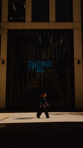 Josh | Beyond Frames on Instagram: "The scene is mostly shadow, with one clean strip of light cutting across the frame. Instead of chasing action, you let the light dictate when the photo happens. . The subject only matters because they step into that light. . This is using negative space intentionally. Darkness simplifies the frame. It removes distractions. It turns a normal walk into a moment. . The vertical lines in the background add structure, but they stay subtle. They don’t compete — they