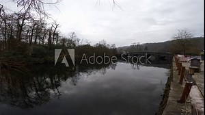 Video footage of Newby Bridge in Cumbria. Showing the River Leven flowing under the historic stone built bridge.