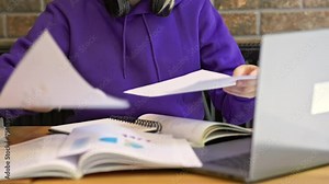 With laptop on table student meticulously organized papers and notes deeply immersed in process of learning. Learning approach reflects essence of education Scene epitomizes learning academic pursuit