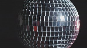 Shiny disco ball spinning with dark background - Free Stock Video
