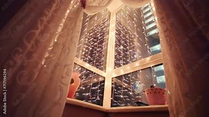 Corner with windows with electric garlands and decorative sheep